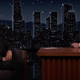 Robert Pattinson, wearing a business casual version of the batsuit, talks to Jimmy Kimmel.
